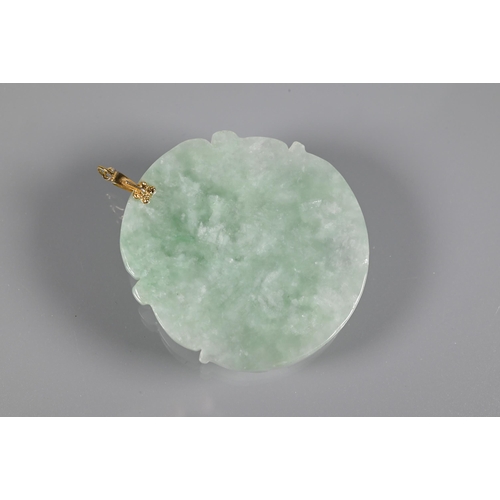 201 - Two carved jade pendants, one in the form of a Buddha, the other a fish and lotus leaf, a jade round... 