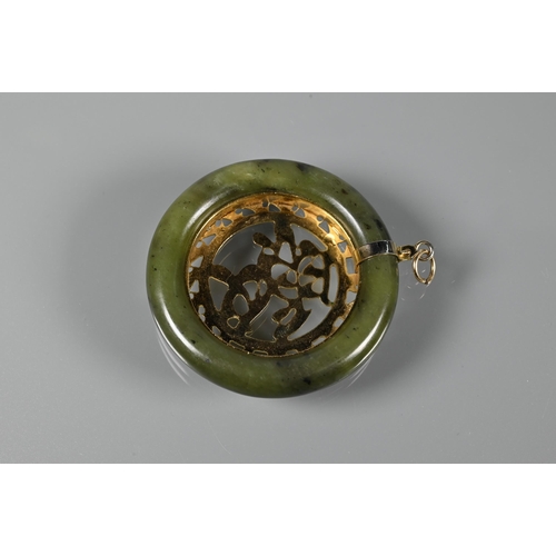 201 - Two carved jade pendants, one in the form of a Buddha, the other a fish and lotus leaf, a jade round... 