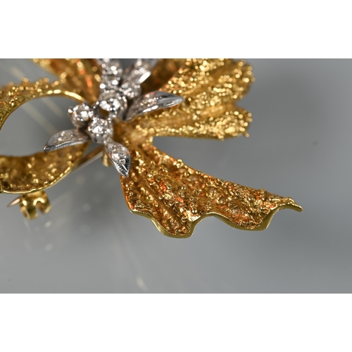 281 - An 18ct yellow gold brooch of textured form, set with mixed cut diamonds, in the form of a bow, appr... 