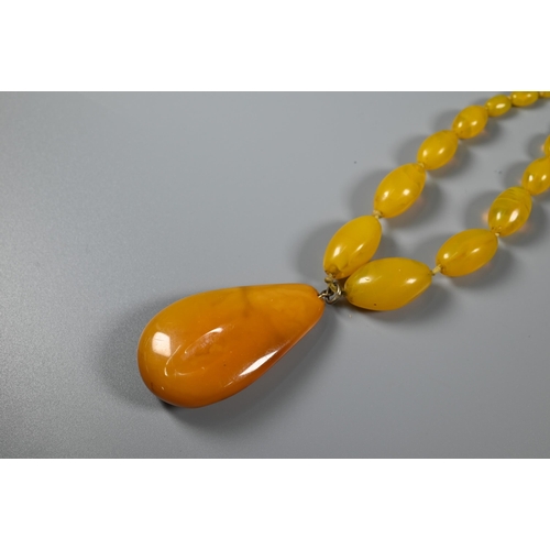 301 - A contemporary white metal necklace formed of textured roundels; a tiger's eye pear-shaped pendant o... 