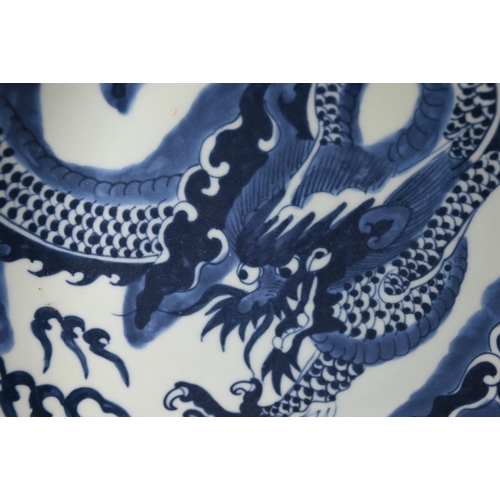 358 - A Chinese transitional style blue and white dragon charger in the mid 17th century manner, painted i... 