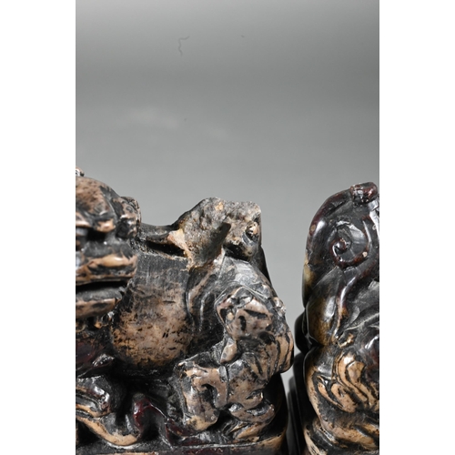 361 - A pair of early 20th century Chinese soapstone desk seals carved with Buddhistic guardian lions and ... 