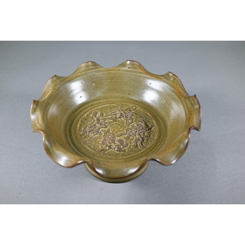 368 - A Chinese Song style stemmed fruit dish with olive green glaze and relief mythical beast decoration,... 