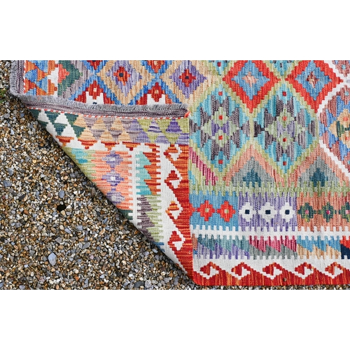 754 - A contemporary wool Afghan Kelim rug, geometric design in colours, 179 cm x 141 cm