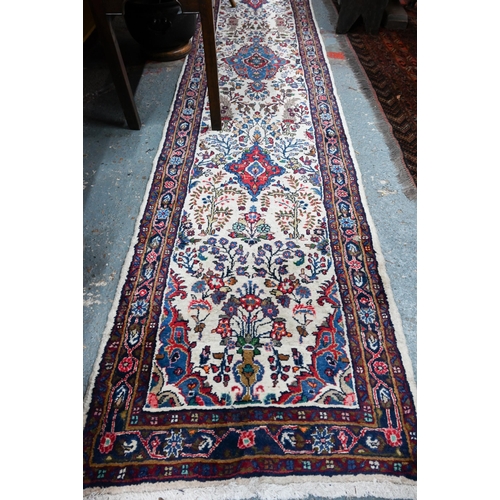 758 - A contemporary North West Persian Sarouk runner, the camel ground with floral designs, 400 cm x 80 c... 