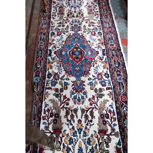 758 - A contemporary North West Persian Sarouk runner, the camel ground with floral designs, 400 cm x 80 c... 