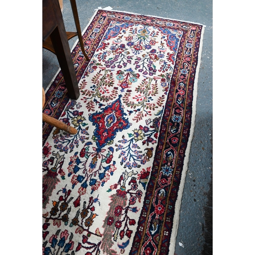 758 - A contemporary North West Persian Sarouk runner, the camel ground with floral designs, 400 cm x 80 c... 