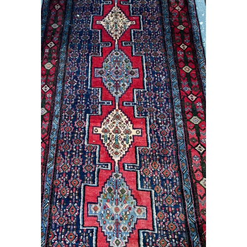 770 - A contemporary North West Persian Senneh runner, with lozenge pole design on red ground, 382 cm x 93... 