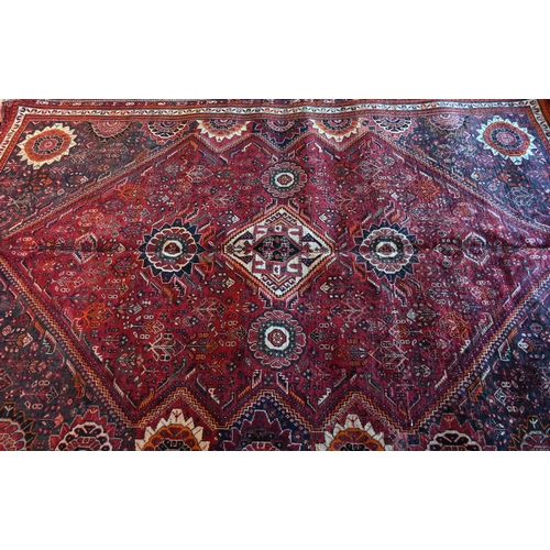 788 - A South West Persian Qashqai carpet, red ground with scattered rosettes within narrow borders,  312 ... 