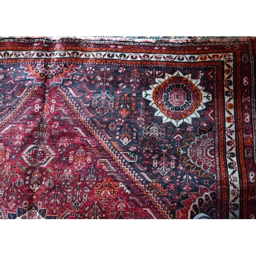 788 - A South West Persian Qashqai carpet, red ground with scattered rosettes within narrow borders,  312 ... 