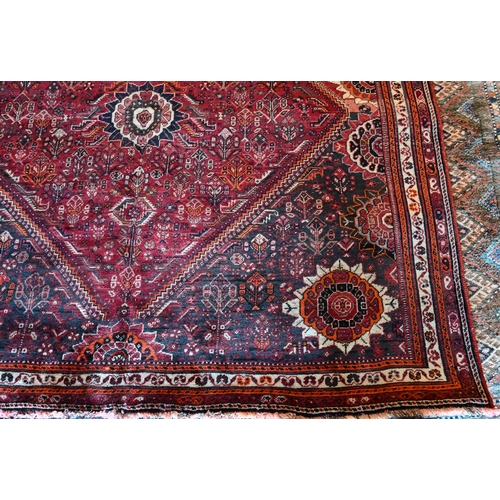 788 - A South West Persian Qashqai carpet, red ground with scattered rosettes within narrow borders,  312 ... 