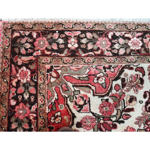 791 - A North West Persian Lilihan rug, traditional centre floral medallion design on soft rose ground, 21... 