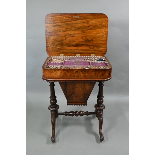 815 - A Victorian walnut veneered work table, the quarter veneered hinged top enclosing a fitted interior ... 