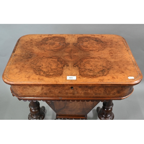 815 - A Victorian walnut veneered work table, the quarter veneered hinged top enclosing a fitted interior ... 