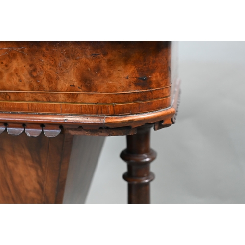 815 - A Victorian walnut veneered work table, the quarter veneered hinged top enclosing a fitted interior ... 