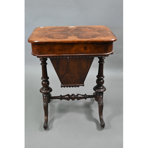 815 - A Victorian walnut veneered work table, the quarter veneered hinged top enclosing a fitted interior ... 