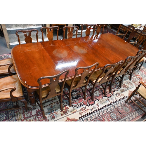 830 - A large Victorian style mahogany extending dining table, the wind action extending to accept three a... 