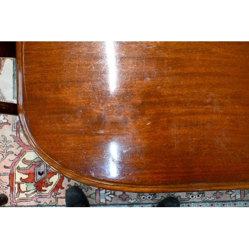 830 - A large Victorian style mahogany extending dining table, the wind action extending to accept three a... 