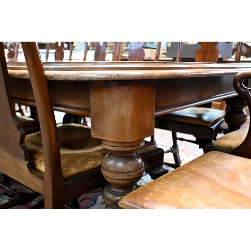 830 - A large Victorian style mahogany extending dining table, the wind action extending to accept three a... 