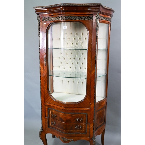 833 - A continental brass mounted kingwood serpentine form salon display cabinet, the interior with button... 