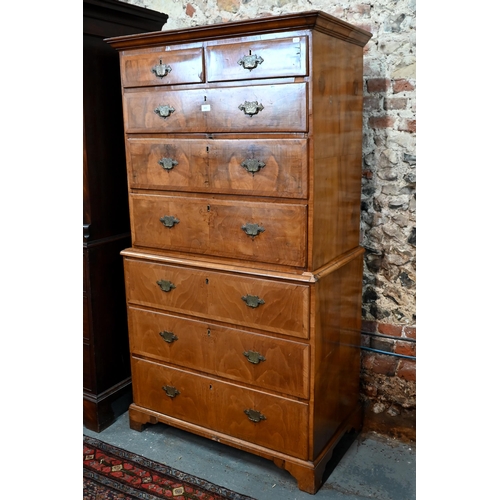 835 - An 18th century cross-banded walnut chest on chest, the moulded cornice over an arrangement of two s... 