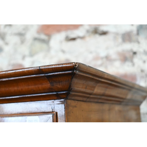 835 - An 18th century cross-banded walnut chest on chest, the moulded cornice over an arrangement of two s... 