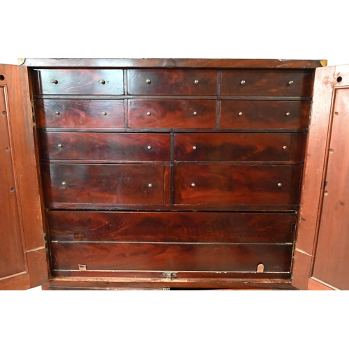 837 - A William IV brass bound figured mahogany two part campaign cabinet, the upper part having a pair of... 