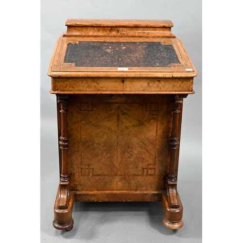 851 - A Victorian walnut Davenport desk, with hinged stage-back enclosing stationary compartments over a m... 