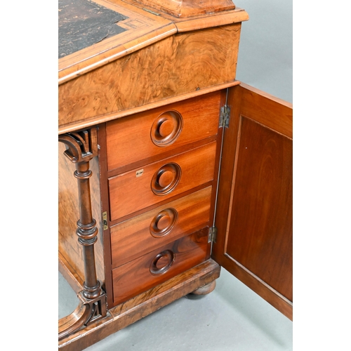 851 - A Victorian walnut Davenport desk, with hinged stage-back enclosing stationary compartments over a m... 