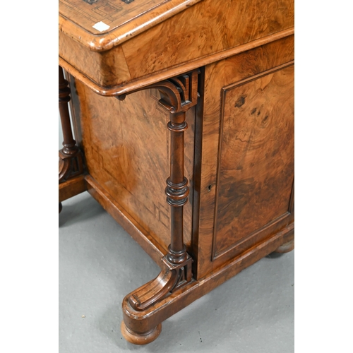 851 - A Victorian walnut Davenport desk, with hinged stage-back enclosing stationary compartments over a m... 