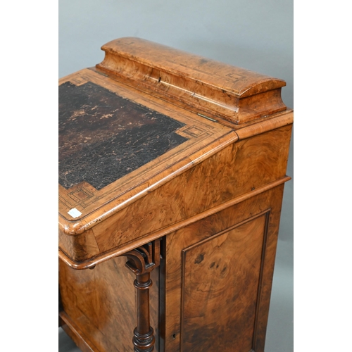 851 - A Victorian walnut Davenport desk, with hinged stage-back enclosing stationary compartments over a m... 