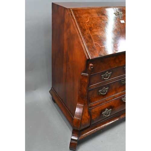 852 - An antique continental walnut 'bombe' bureau, the slope front with leather interior and enclosing a ... 