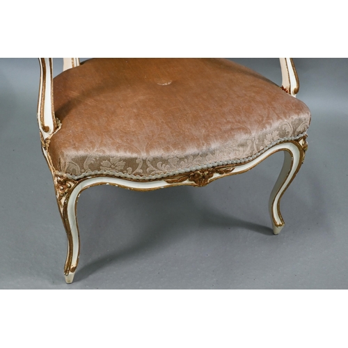 855 - A pair of antique French fauteuils with fabric panelled backs and overstuffed seats, raised on cabri... 