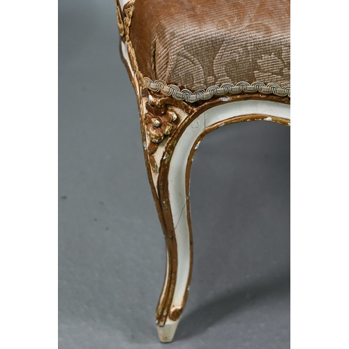 855 - A pair of antique French fauteuils with fabric panelled backs and overstuffed seats, raised on cabri... 