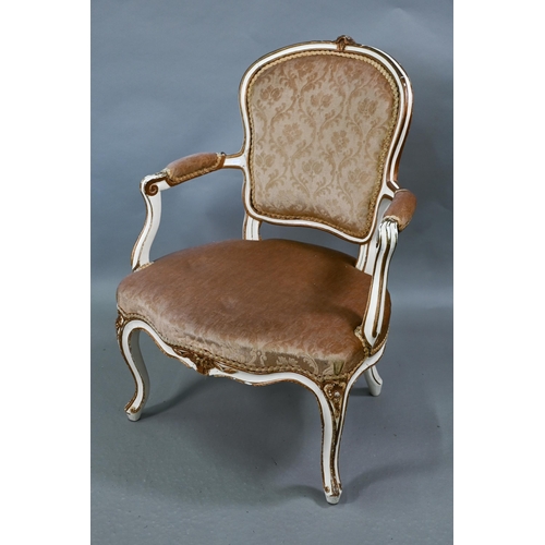 855 - A pair of antique French fauteuils with fabric panelled backs and overstuffed seats, raised on cabri... 