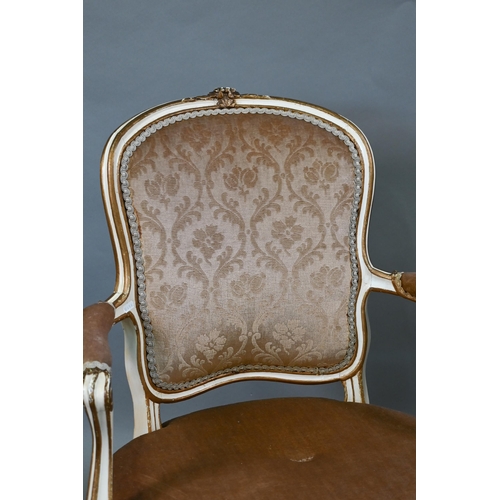 855 - A pair of antique French fauteuils with fabric panelled backs and overstuffed seats, raised on cabri... 