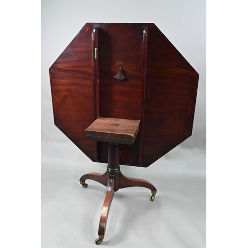 866 - A George III cross-banded mahogany breakfast table, the octagonal tilt-top raised on a gun-barrel su... 