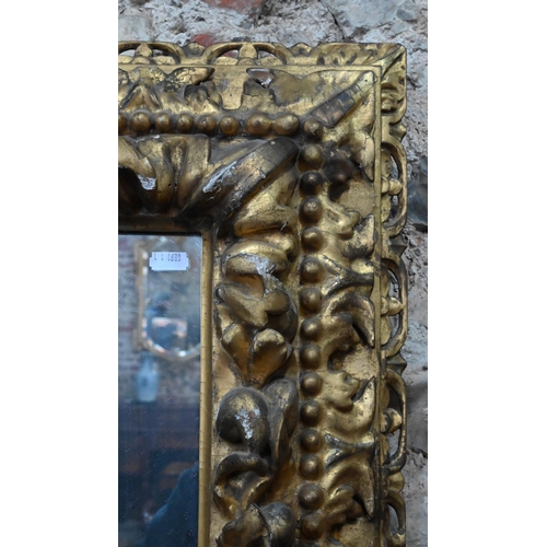 879 - An 18th century gesso, composite and giltwood picture frame, formed with birds and floral buds, with... 