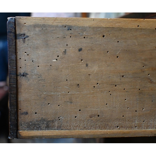 883 - An 18th century fruitwood and oak/elm dresser, the wavy cornice top with plank back over three shelv... 