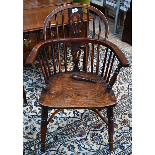 960 - A 19th century yew and elm Windsor hoop back elbow chair, raised on turned legs united by a crinolin... 