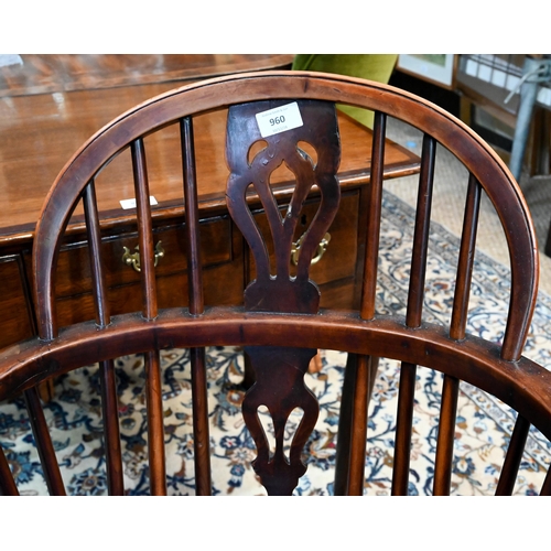 960 - A 19th century yew and elm Windsor hoop back elbow chair, raised on turned legs united by a crinolin... 