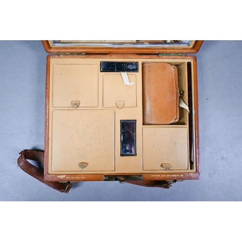 973 - A Davis of Piccadilly - a vintage tan leather vanity handbag, fully fitted with compartments includi... 