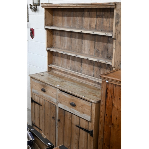 104 - # An antique pine provincial dresser with graduated plate rack over two drawers and cupboards, 36 cm... 