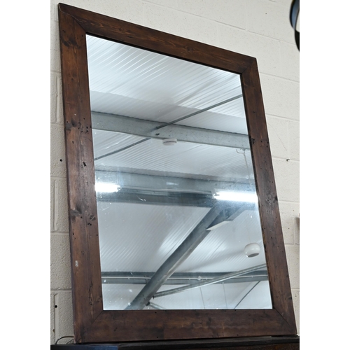 120 - A large rectangular over-mantel mirror in rustic stained pine frame, 142 cm x 114 cm