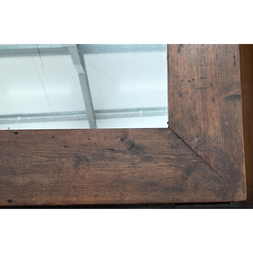 120 - A large rectangular over-mantel mirror in rustic stained pine frame, 142 cm x 114 cm