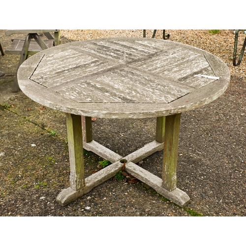 2 - A weathered Lister teak circular garden table, 165 cm dia. to/w a set of four Lister teak reclining ... 