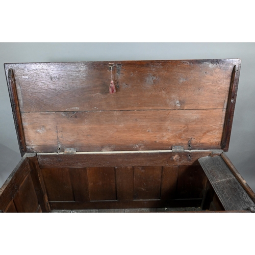 193 - A 17th century oak coffer, the wide two plank top over a lunette carved frieze and four diamond inci... 