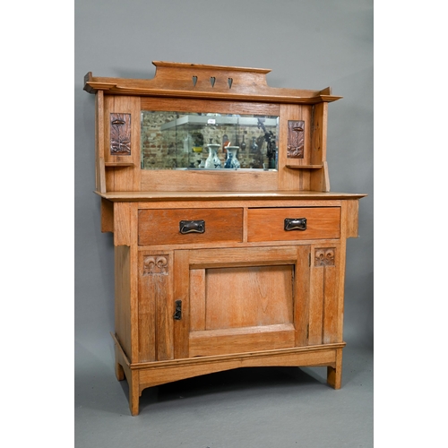 216 - An early 20th century Arts & Crafts mirror backed oak sideboard, the bevel edged plate flanked b... 