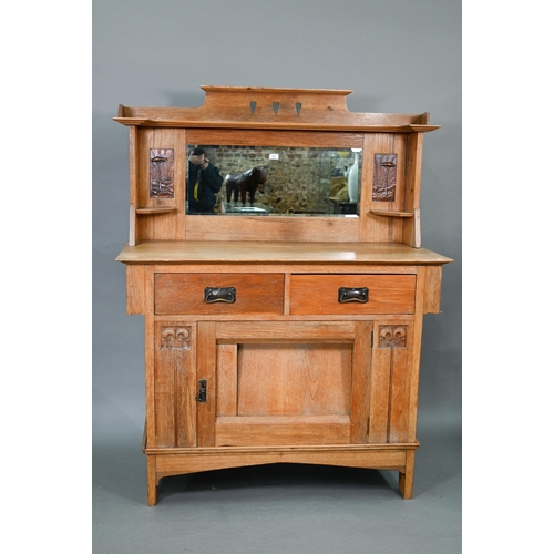 216 - An early 20th century Arts & Crafts mirror backed oak sideboard, the bevel edged plate flanked b... 