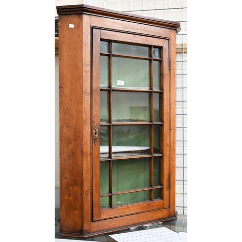 116 - An 18th century fruitwood glazed corner cupboard with painted interior, 102 cm h